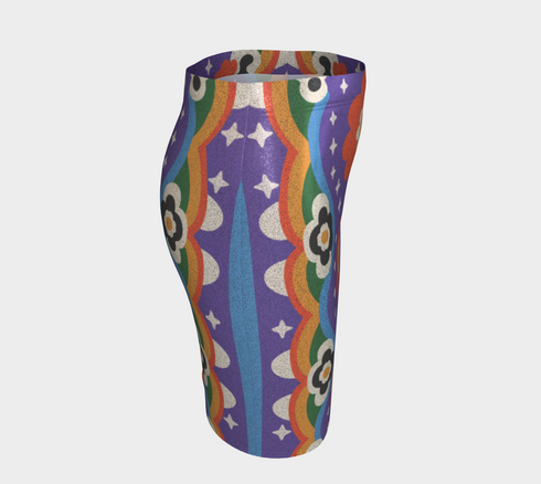 Form-fitting bodycon mini skirt with a mid-rise elastic waistband, falling to mid-thigh in smooth stretch fabric. It features a bold groovy mod floral print: oversized orange flowers with white inner petals and golden yellow centers, black flower accents, and white four-point sparkles, all set on a deep purple background. Rainbow borders in blue, green, orange, and yellow run down each side. The all-over design is a flat dye-sublimated print, available in a smooth knit or glitter knit finish.