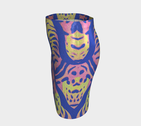 High-waisted mini skirt with a vibrant pastel tiger stripe pattern in electric blue, soft pink, yellow, and violet. The bodycon silhouette hugs curves with a comfy elastic waistband and stretch fabric. Available in smooth performance fabric or glitter finish. A maximalist fashion piece for festivals, summer outfits, and ravewear.