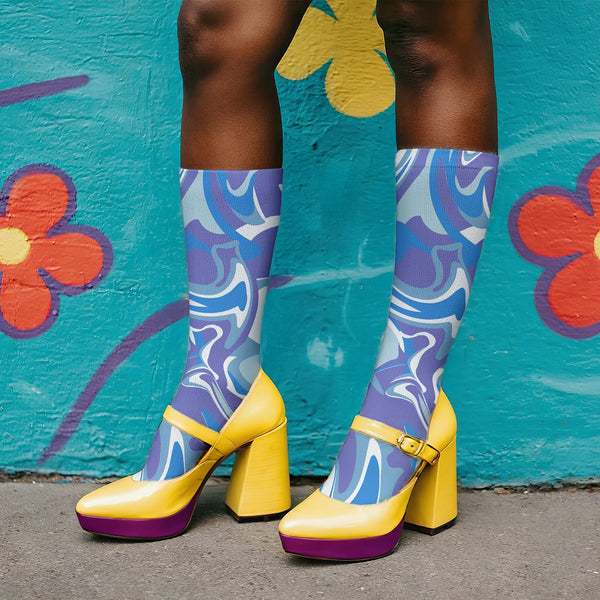 Psychedelic ankle socks featuring a bold blue and purple marble swirl pattern with black reinforced heel and toe, made from a stretchy polyester, nylon, and spandex blend, one size fits most, unisex, vibrant statement accessory for alternative and festival fashion lovers.