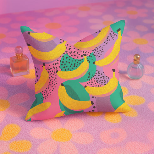 Colorful square pillow cover featuring a bold banana print in yellow, pink, green, purple, and black. The print appears on both sides and is made of luxe polyester with a linen-like texture. Hidden zipper closure. Available in two sizes: 22x22 inches and 18x18 inches. Designed for bright, dopamine-style, maximalist home decor.