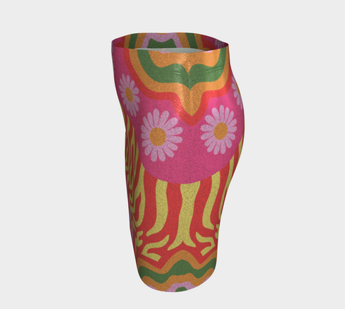 Form-fitting mini skirt featuring a vibrant, retro-inspired maximalist pattern. The design showcases a diagonal hot pink band filled with white and yellow daisies, contrasting against a bold background of wavy, abstract red and yellow flame-like stripes. The bottom edge includes curved color blocks of green and orange. Made of a smooth, stretchy fabric with a mid-rise elastic waistband, hitting at mid-thigh. Available in both a matte black-light reactive finish and a metallic glitter finish.