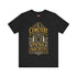 A black unisex crewneck graphic t-shirt featuring an ornate Victorian-inspired emblem printed on the chest in vintage gold and off-white. The centralized, symmetrical design showcases a classic coffin with a cross on the lid, flanked by wrought-iron cemetery gates. Beautiful scrollwork and decorative filigree flourishes surround the bold, retro serif text reading CEMETERY PICNIC SOCIETY. A crescent moon and stars sit at the top, completing this gothic memento mori graphic shirt.