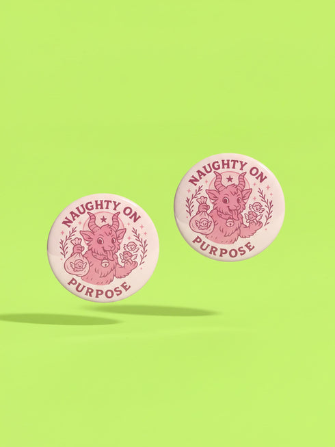 Set of 4 1.75 inch round pastel goth holiday pinback buttons. 1: Light pink with Baphomet head in wreath reading Merry Hexmas Hail Yourself. 2: Dark mauve with skull mistletoe reading Kiss Me or Perish. 3: Dark mauve with coffin stocking and black cat reading All I Want is Doom. 4: Light pink with cute Baphomet holding a sack reading Naughty on Purpose. All feature durable tinplate construction, high gloss laminate finish, and a secure metal safety pin back.