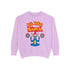 A Christmas sweatshirt featuring a playful design with a cartoon Baphomet goat character wearing a Santa hat. The design includes the text "All Hail Santa" above the goat, with pentagrams in flames on either side. The goat is depicted in a meditative pose, adding a humorous and irreverent twist to holiday attire.