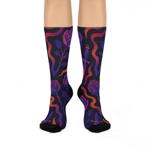 Mid-calf socks with a dark violet-black base featuring a gothic dagger and rose design in gradient shades of red, purple, and pink, with black heels and toes and an illustrated snake detail.