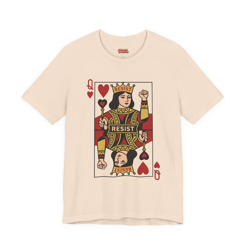A centralized graphic design of a Queen of Hearts playing card on a cream or pink unisex t-shirt. The Queen is depicted in a maximalist folk art style, holding a heart-topped scepter and a raised fist in a gesture of solidarity. The word "RESIST" is visible on her crown and a central banner in ochre and true red tones. The layout is a centralized medallion style with rust and ochre accents and a playing card border.