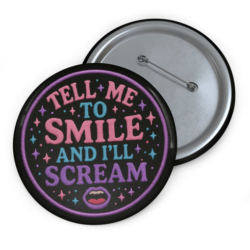 Glossy black pinback button with pastel-colored embroidered-style text that reads “Tell Me to Smile and I’ll Scream,” with lips icon and star accents.