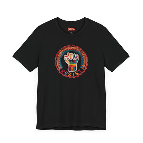 Black short-sleeve t-shirt featuring a bold embroidered design centered on the chest. The design showcases a raised fist wrapped in multicolored thread, symbolizing strength and resistance. Surrounding the fist is a circular embroidered border with intricate, colorful stitching in shades of red, orange, blue, and yellow, creating a striking contrast against the black fabric. Below the fist, the word "RESIST" is embroidered in capital letters using a gradient of warm-toned thread. The t-shirt has a classic c