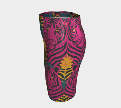 High-waisted mini skirt with bold psychedelic tiger print in hot pink, teal, yellow, and black. Features a form-fitting pencil silhouette with an elastic waistband. Available in eco-poly performance or glitter finish. Unique maximalist style for festivals, summer parties, or rave fashion. Sizes S–XL.