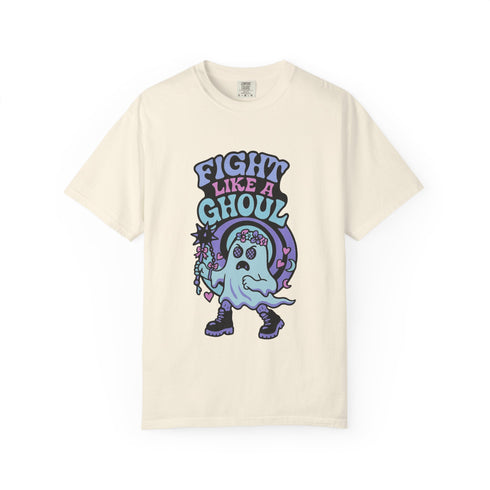 Unisex Comfort Colors 1717 t-shirt featuring a front print of a cute gothic ghost holding a mace wand with text reading "Fight Like A Ghoul." The ghost has floral details, combat boots, and pastel accents. Made of soft-washed, 100% ring-spun cotton with garment-dyed fabric and seamless tubular knit construction. Available in sizes S to 4XL.