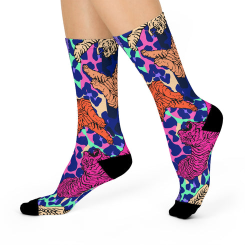 Stylish jungle-themed socks with tigers and abstract camo patterns in a palette of purple, blue, and pink, laid out on a yellow background, ideal for adding a pop of color to your wardrobe