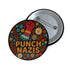 Round black pinback button with bold embroidered-style design featuring a raised red fist, zigzag sleeve, and colorful folk art flowers in orange, teal, yellow, and white. Center text reads “PUNCH NAZIS” in bright golden thread-style lettering. The design is bold, anti-fascist, and maximalist, shown on a glossy pin surface against a pink and purple gradient background. Statement accessory for protest fashion, punk style, and political activism.