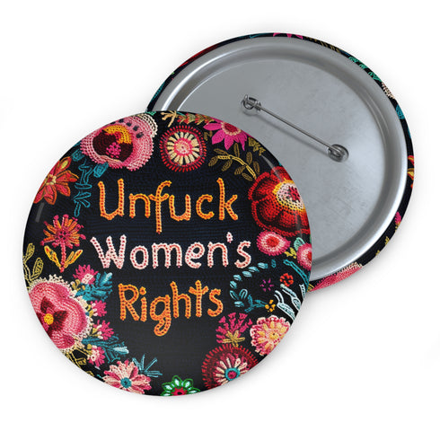 Round pinback button with black background featuring vibrant floral embroidery design surrounding bold orange and white text reading "Unfuck Women's Rights" - feminist protest accessory with glossy finish, safety pin backing, available in 2" and 3" sizes for jackets, bags, and activist wear.