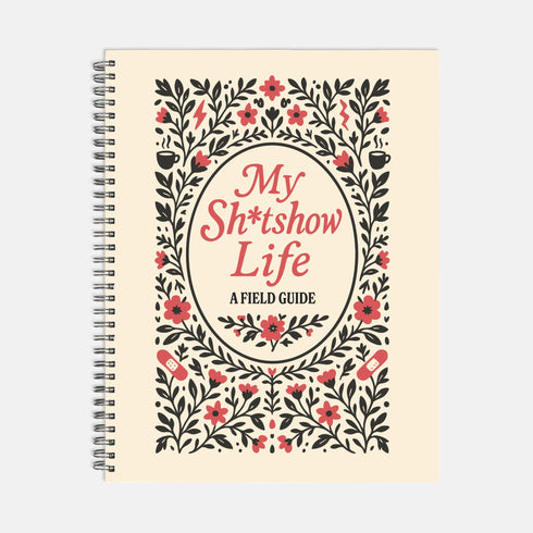 An 8.5 x 11 inch hardcover spiral-bound planner with a cream-colored cover featuring red and black folk art style floral illustrations. The cover reads "My Sh*tshow Life: A Field Guide" in a retro serif font. The planner has a durable satin matte laminated cover adhered to chipboard and a metal wire-o spiral binding available in gold or black. Interior pages are undated and include monthly and weekly layouts with sections for notes, to-do lists.