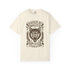 Vintage style graphic t-shirt with a large snarling wolf face printed in dark charcoal ink. A curved banner above reads RAISED BY WOLVES and a banner below reads RADICALIZED BY LEGISLATION, framed by stylized flames and scattered stars. Classic crewneck short sleeve cotton tee with a relaxed fit and seamless sides, available in soft pink, pale green, and ivory. Feminist protest apparel and activist statement tee for reproductive rights, marches, and everyday quiet rage.