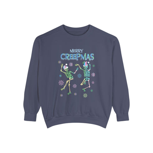 A dark green holiday sweatshirt featuring two dancing skeletons wearing Santa hats. The text "Merry Creepmas" is displayed above them in icy, drippy font. The design is surrounded by colorful snowflakes, blending spooky and festive elements for a fun, alternative holiday look.