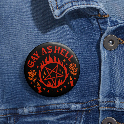 Round glossy pinback button measuring 2.25 inches with bold red graphic design on a black background. Text reads “Gay As Hell” above a red pentagram surrounded by flames, stars, roses, and candles. Made of tinplate with a safety pin back and a scratch-resistant mylar finish. The button features a high-gloss surface and is lightweight and durable, perfect for jackets, bags, or accessories.