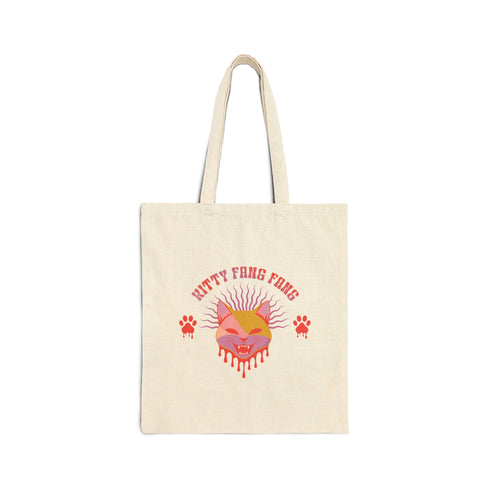 Edgy cat tote with attitude. Vibrant pink and orange design features snarling feline face, dripping fangs, and 'Kitty Fang Fang' text. Playful yet fierce vibe on natural canvas. Perfect for cat lovers with a wild side.