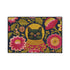 High-fidelity printed doormat featuring a "Space Kitty" design in a tapestry-style faux-texture. A black cat with large yellow eyes wears a golden ribbed space helmet, centered on a deep navy background. The cat is surrounded by oversized, vibrant magenta and pink folk-art flowers with chartreuse and olive green leaves. The design uses a printed illusion to mimic 3D embroidery stitching. The mat is rectangular with a sleek black border and a non-slip backing.