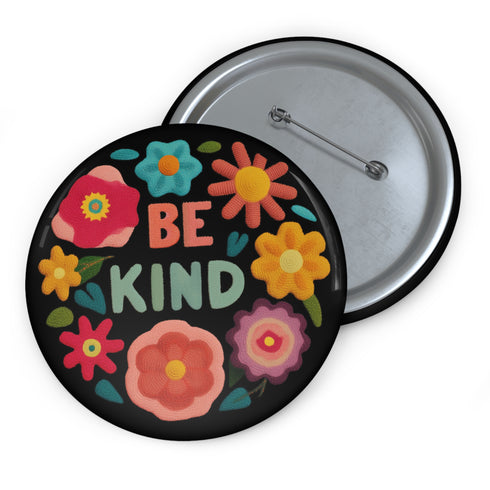 Bold "BE KIND" pinback button featuring vibrant psychedelic flowers in hot pink, teal, yellow, and orange on black background. Retro 70s-inspired typography in coral and mint green surrounded by colorful blooms. Statement activist accessory perfect for punk fashion, protest wear, and battle vests. Glossy UV-resistant finish with safety pin backing available in 2" and 3" sizes.