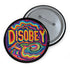 Round black pinback button with neon embroidery-style waves surrounding bold yellow and red "DISOBEY" text.