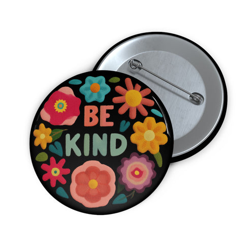 Bold "BE KIND" pinback button featuring vibrant psychedelic flowers in hot pink, teal, yellow, and orange on black background. Retro 70s-inspired typography in coral and mint green surrounded by colorful blooms. Statement activist accessory perfect for punk fashion, protest wear, and battle vests. Glossy UV-resistant finish with safety pin backing available in 2" and 3" sizes.