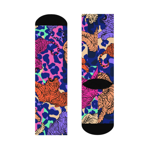 Stylish jungle-themed socks with tigers and abstract camo patterns in a palette of purple, blue, and pink, laid out on a yellow background, ideal for adding a pop of color to your wardrobe