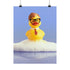 A humorous fine art print of a rubber duck modeled after Dwight Schrute, complete with glasses, mustard tie, and serious expression. Floating in soap suds, the print is framed above a retro bed with bold orange flower wallpaper and bright accent pillows.
