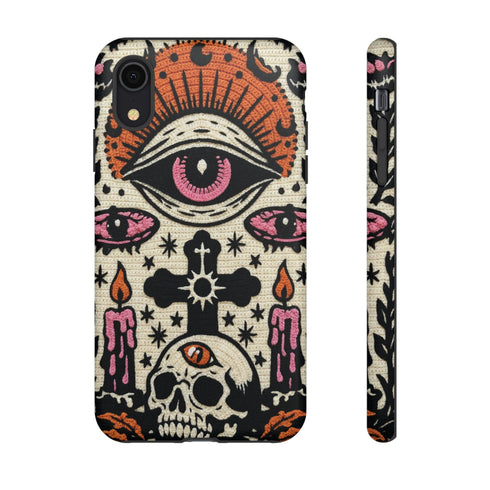 A vertical phone case design featuring a faux crochet texture illusion printed on a cream background. The symmetrical pattern centers on a large black eye with a pink iris and rust-orange sunburst lashes at the top. Below the eye is a black cross surrounded by small black stars. The bottom features a skull with a third rust-orange eye on its forehead. Flanking the skull are two candles with orange flames and rust-colored leaves. The design mimics the look of stitched yarn but is a 2d print.