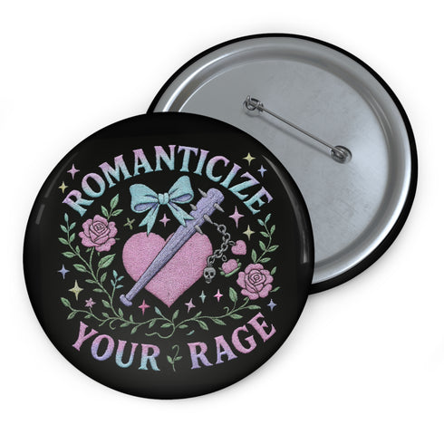 Glossy black pinback button featuring pastel gothic artwork with the phrase "Romanticize Your Rage" in bold white and lavender lettering. The design includes a pink glitter heart, a silver dagger, mint green bow, roses, stars, and delicate vines. Styled against a pink and purple gradient background, this round button blends soft romantic visuals with fierce messaging, perfect for pastel goth, feminist, or alternative fashion aesthetics.