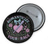 Glossy black pinback button featuring pastel gothic artwork with the phrase "Romanticize Your Rage" in bold white and lavender lettering. The design includes a pink glitter heart, a silver dagger, mint green bow, roses, stars, and delicate vines. Styled against a pink and purple gradient background, this round button blends soft romantic visuals with fierce messaging, perfect for pastel goth, feminist, or alternative fashion aesthetics.