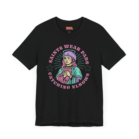 Black unisex t-shirt with bold graphic that reads "Saints Wear Pads Catching Elbows" surrounding a pastel saint figure wearing a roller skate helmet and protective pads. The design mimics embroidery in a retro tattoo-inspired art style. Available in sizes S to 3XL, this skate tee is soft, comfortable, and perfect for roller derby lovers, punk skaters, and feminist fashion fans. Great birthday or skate party gift idea.