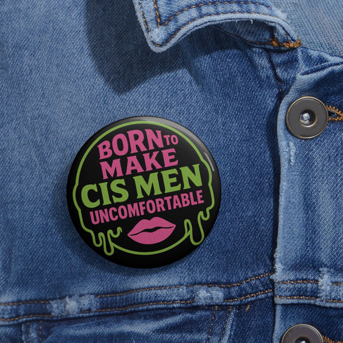 Glossy black pinback button featuring bold text 'Born to Make Cis Men Uncomfortable' in pink and green glitter fonts. Design includes melting skull outline and lips illustration. Button is round and 2.25 inches in diameter with a durable tinplate body and UV-resistant coating. Perfect for jackets, backpacks, or gifts for queer punks and feminists.