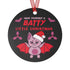 Round black metal Christmas ornament featuring cute pink bat with red wings wearing Santa hat, surrounded by pink bats and holly. Text reads "Have Yourself A Batty Little Christmas