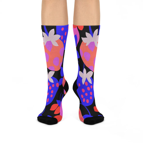 Black crew socks featuring an oversized, abstract strawberry pattern in bright pink, blue, and orange.