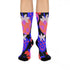 Black crew socks featuring an oversized, abstract strawberry pattern in bright pink, blue, and orange.