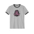 Off-white ringer t-shirt with black contrast trim on the collar and sleeve cuffs. The front features a bold, high-contrast graphic of an open mouth with the phrase "EAT THE RICH" in capital letters, styled in a hand-drawn font. The design is rendered in black and vibrant pink, with expressive line details surrounding the mouth, adding a dynamic, rebellious feel. The t-shirt has a vintage-inspired fit, made from soft cotton fabric with a slightly relaxed silhouette. The black trim enhances the retro aestheti