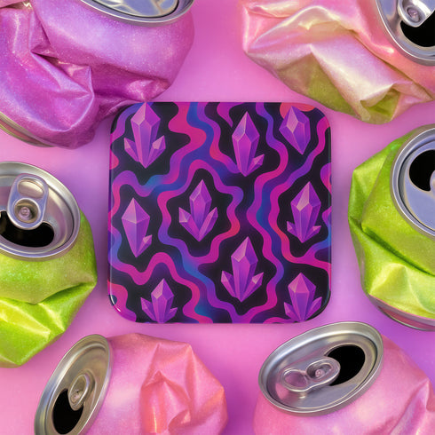 Square drink coaster with a psychedelic design featuring bright purple crystal shards over pink and black wavy patterns. The coaster is made from hardboard MDF with a cork backing and a high-gloss finish. It measures 3.74 by 3.74 inches and is water-repellent, heat-resistant, and easy to clean. Ideal for pastel goth, witchy, coquette, or maximalist room decor and gifting occasions.