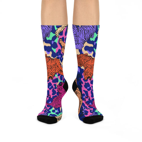 Stylish jungle-themed socks with tigers and abstract camo patterns in a palette of purple, blue, and pink, laid out on a yellow background, ideal for adding a pop of color to your wardrobe