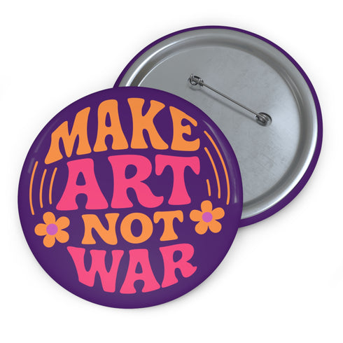 A round, glossy purple pinback button with the words "MAKE ART NOT WAR" in a groovy, retro 70s-style font. The word "MAKE" is in orange, "ART" is in a vibrant pink, and "NOT WAR" is in orange. The text is surrounded by small, stylized flower and star details. This psychedelic protest pin is a piece of activist merch with a strong metal back and safety pin clasp, perfect as an anti-war or social justice accessory for a jean jacket or backpack. The pin has a handmade, indie aesthetic.
