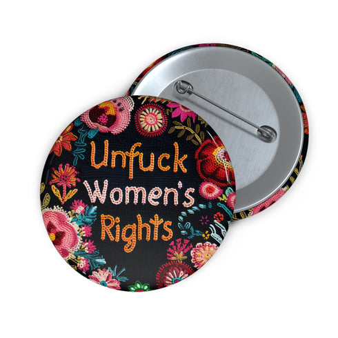 Round pinback button with black background featuring vibrant floral embroidery design surrounding bold orange and white text reading "Unfuck Women's Rights" - feminist protest accessory with glossy finish, safety pin backing, available in 2" and 3" sizes for jackets, bags, and activist wear.