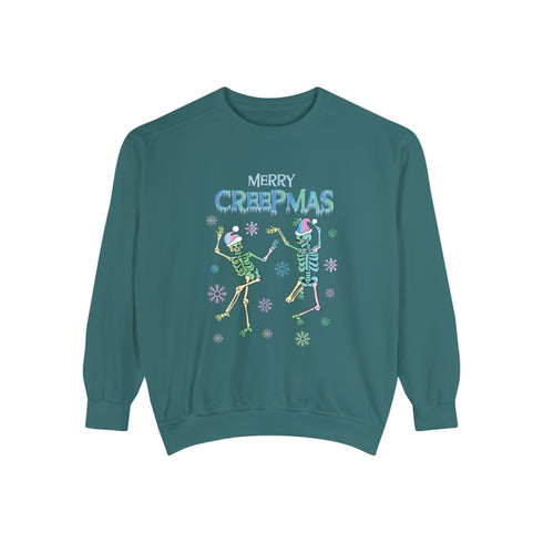 A dark green holiday sweatshirt featuring two dancing skeletons wearing Santa hats. The text "Merry Creepmas" is displayed above them in icy, drippy font. The design is surrounded by colorful snowflakes, blending spooky and festive elements for a fun, alternative holiday look.