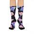 Black crew socks with an allover design of iridescent neon mushrooms in shades of pink, blue, and purple.
