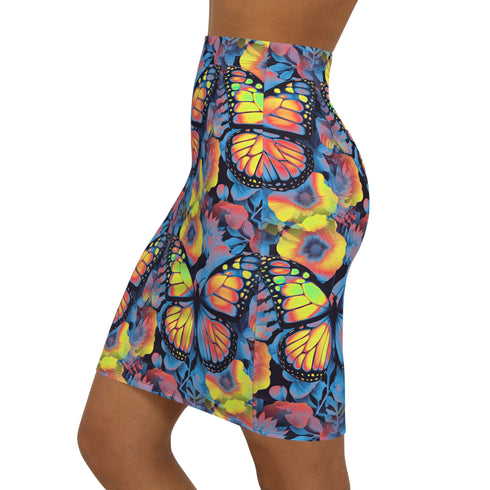 High-waisted bodycon mini skirt with an allover print of rainbow monarch butterflies and colorful tropical flowers on a dark background. Soft, stretchy poly-spandex fabric hugs the body for a flattering fit. Styled for rave, Y2K, and festival outfits. Sizes XS to XL.