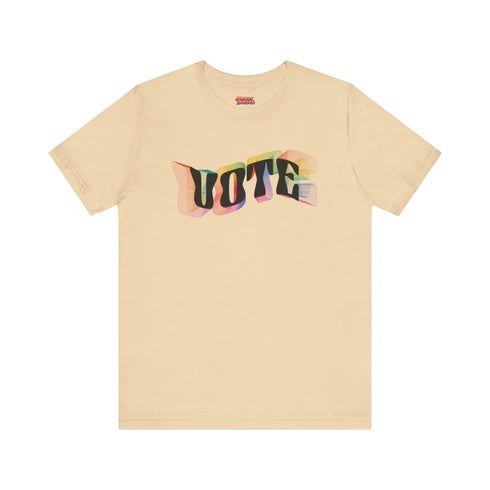 Election 2024 t-shirt with "VOTE" printed in large, colorful letters. Each letter features a different color from the rainbow spectrum, styled in a groovy 70s-inspired font.