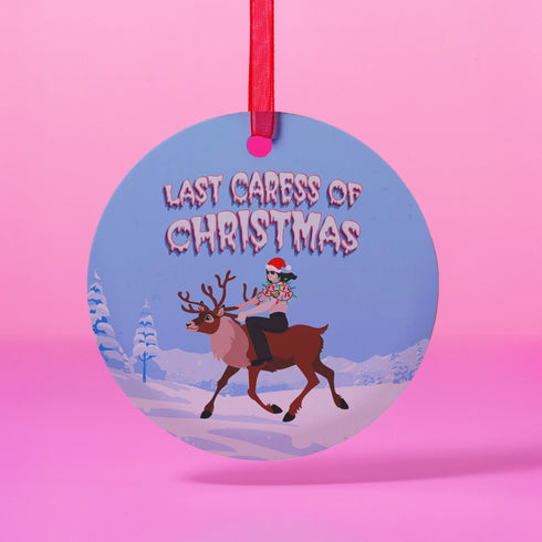 Round blue metal Christmas ornament featuring Glenn Danzig in sunglasses and Christmas lights riding reindeer through snowy landscape. Text reads "Last Caress of Christmas" in icy font.