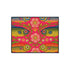 Rectangular indoor outdoor doormat featuring a vibrant hot pink background with a symmetrical maximalist pattern. The design showcases stylized sardines in yellow, lime green, and cobalt blue swimming horizontally towards a central vertical axis of blooming pale pink flowers and green vines. The imagery mimics the texture of vintage needlepoint embroidery but is a flat print on polyester. The mat is framed by a sleek black trim and features a non-slip rubber backing for safety.