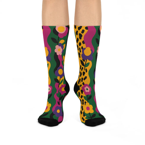 Colorful dopamine-infused crew socks with an all-over print featuring abstract flowers and leopard spots in bold hues of pink, purple, yellow, green, and black. Made of plush polyester-spandex blend, with black toe and heel accents. Designed to fit women’s US 5 to men’s US 12 shoe sizes.