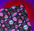 Spooky birthday wrapping paper with neon pink skulls, blue coffins, eyeballs, and bats on black background. Vibrant and gothic design for unique gift presentation.