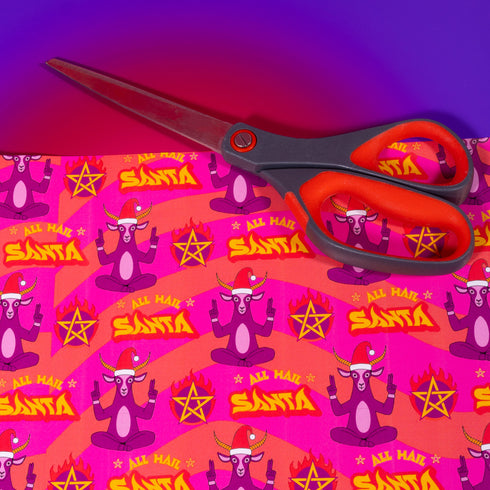 Vibrant pink wrapping paper featuring Occult symbol Baphomet Santas throwing horns, surrounded by flaming pentagrams and "All Hail Santa" text. A punk rock twist on Christmas gift wrap.
